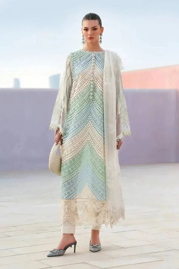 Woman wearing a colorful dress with a white dupatta on a blurred background