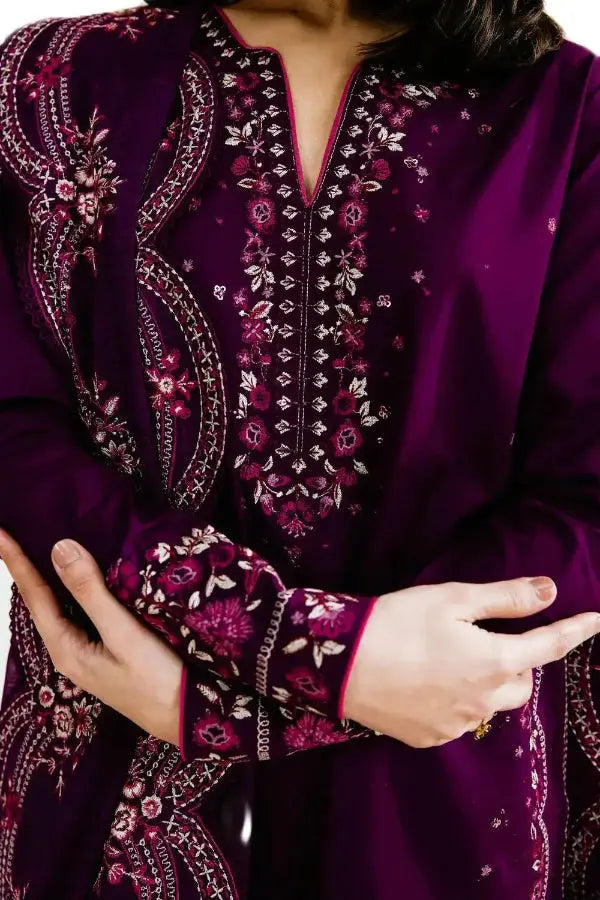 Close-up of a purple embroidered garment with intricate patterns.